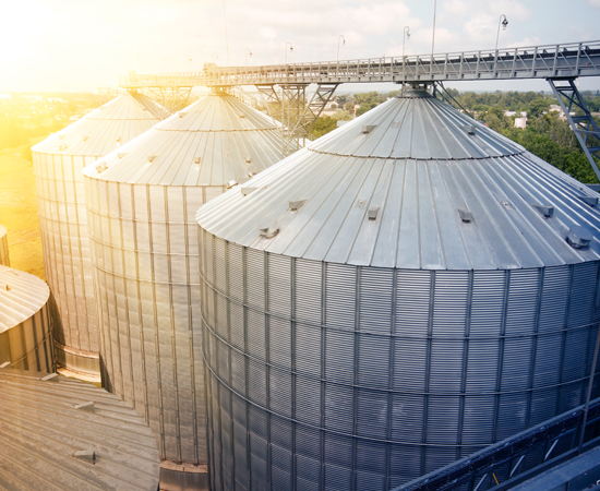 Hydraulics_Agriculture Large metal silos and conveyor belt used for agriculture