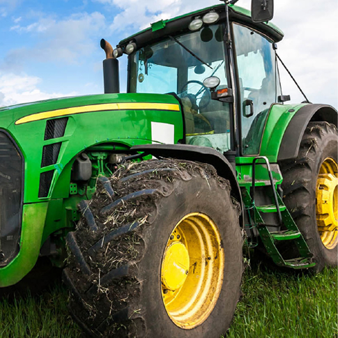 green tractor in grass field