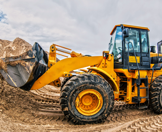 Hydraulics_Construction Loader truck scooping dirt at construction site